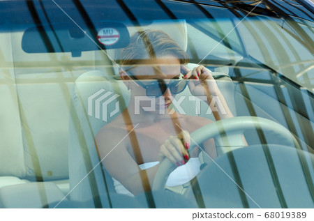 Woman driving a car Woman driving a car 68019389