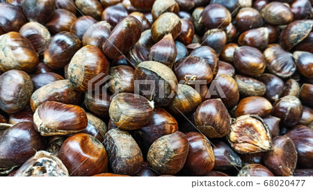 Fresh ripe chesnuts on the sack napkin for Christmas and autumn season Fresh ripe chesnuts on the sack napkin for Christmas and autumn season 68020477