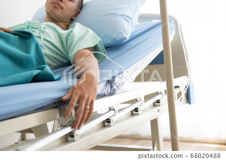 Young Man Lying On Bed At Hospital Young Man Lying On Bed At Hospital 68020488