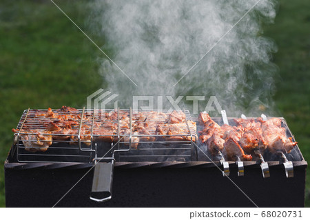 grill barbecue meat on a brazier with smoke, green grill barbecue meat on a brazier with smoke, green 68020731