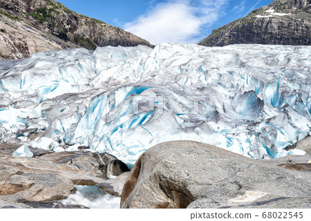 glacier tongue descends to a mountain river 68022545