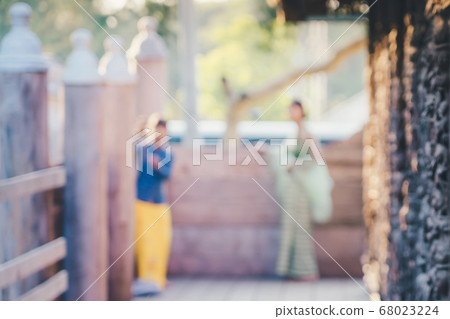 Blur of Female tourist take a photo at Shwe Nan Daw Kyaung (Golden Palace Monastery) in Mandalay, Myanmar. Blur of Female tourist take a photo at Shwe Nan Daw Kyaung (Golden Palace Monastery) in Mandalay, Myanmar. 68023224