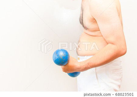 A middle-aged overweight man is doing muscle training with an iron array 68023501