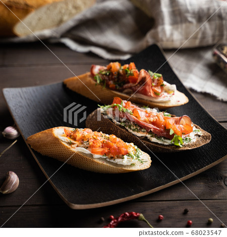 Exquisite sandwiches on square plate 68023547