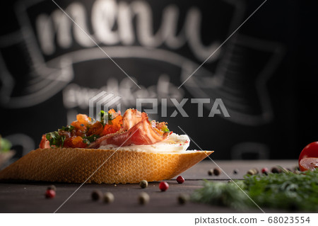 Tasty bruschetta with bacon on table 68023554