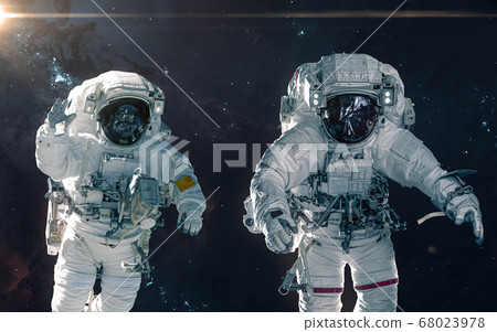 Two astronauts on background of nebulae and star clusters. Deep space landscape 68023978