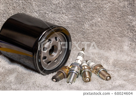 Motorcycle repair parts Spark plug and oil filter Background/image table photo 68024604