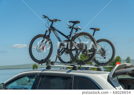 bicycles are attached to the trunk of the car. concept of active recreation. bicycles are attached to the trunk of the car. concept of active recreation. 68026654