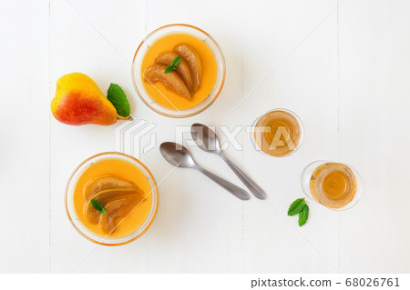 Panna cotta Italian traditional dessert with pears poached in rum and honey syrup. Panna cotta Italian traditional dessert with pears poached in rum and honey syrup. 68026761