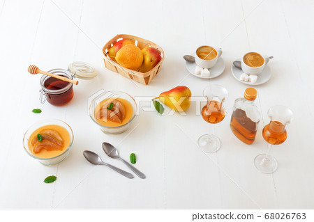 Panna cotta Italian traditional dessert with pears poached in rum and honey syrup. Panna cotta Italian traditional dessert with pears poached in rum and honey syrup. 68026763