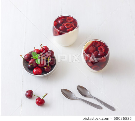Panna cotta Italian traditional dessert with cherries poached in rum and honey syrup.  68026825