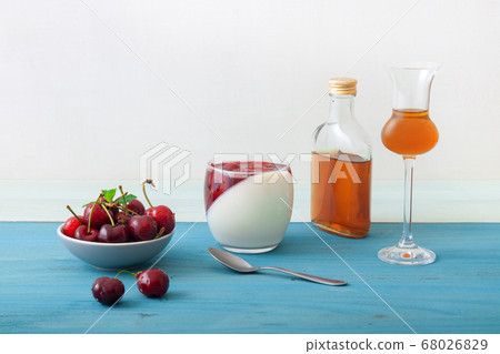 Panna cotta Italian traditional dessert with cherries poached in rum and honey syrup.  68026829