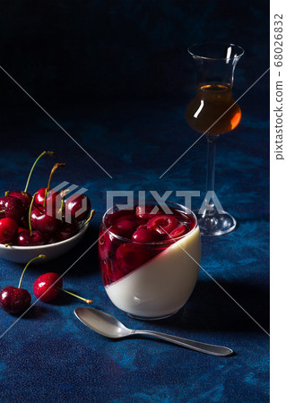 Panna cotta Italian traditional dessert with cherries poached in rum and honey syrup.  68026832