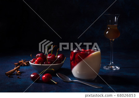 Panna cotta Italian traditional dessert with cherries poached in rum and honey syrup.  68026853
