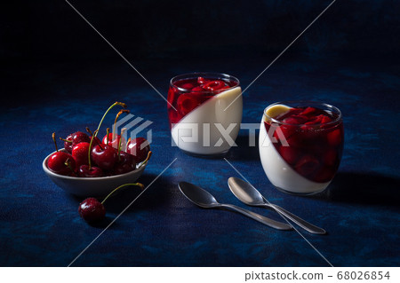 Panna cotta Italian traditional dessert with cherries poached in rum and honey syrup.  68026854