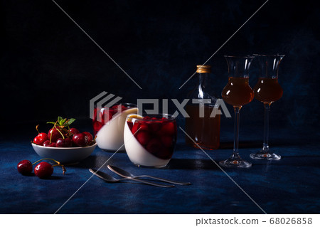Panna cotta Italian traditional dessert with cherries poached in rum and honey syrup.  68026858