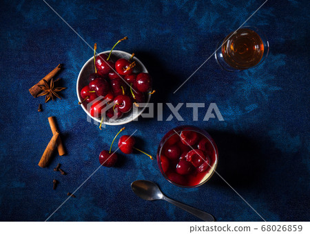 Panna cotta Italian traditional dessert with cherries poached in rum and honey syrup.  68026859