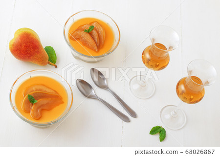 Panna cotta Italian traditional dessert with pears poached in rum and honey syrup. 68026867