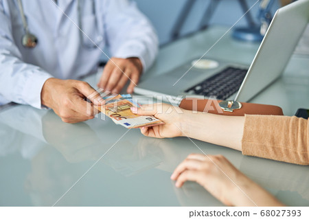 Payment to a doctor for medical care. paid medicine concept Payment to a doctor for medical care. paid medicine concept 68027393