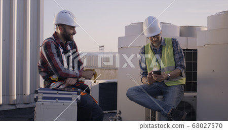 Engineers having a break on a cell tower 68027570