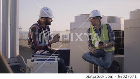 Engineers having a break on a cell tower 68027571