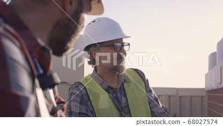 Engineers having a break on a cell tower 68027574