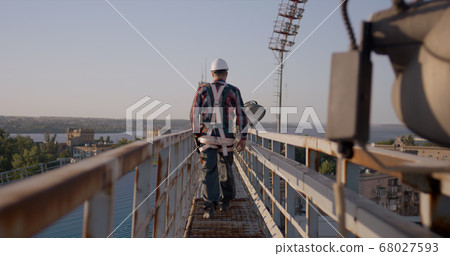 Engineer walking on a cellular tower 68027593