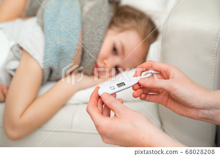 thermometer in mom hands background sick daughter. 68028208