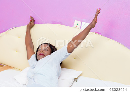 young woman wakes up 68028434