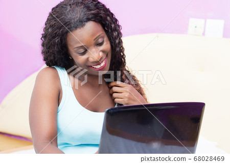 happy young woman using a laptop. 68028469