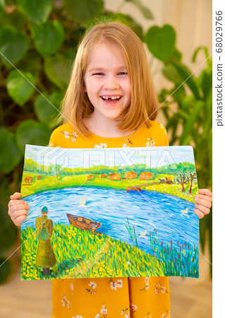 cheerful little girl in yellow dress with pattern 68029766