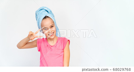 smiling girl in blue towel and pink t-shirt. 68029768