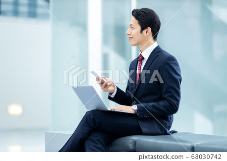 Businessman is working in office building Businessman is working in office building 68030742