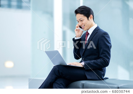 Businessman is working in office building Businessman is working in office building 68030744