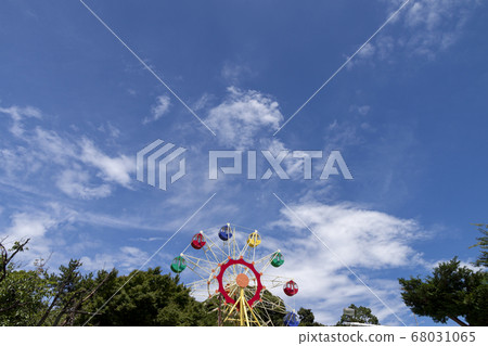 An amusement park gondola with the blue sky and cirrus behind An amusement park gondola with the blue sky and cirrus behind 68031065