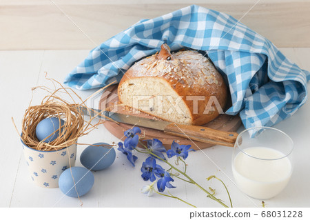 Breakfast with Easter symbols, traditional Czech pastry Mazanec, Pomlazka and eggs in blue style. Breakfast with Easter symbols, traditional Czech pastry Mazanec, Pomlazka and eggs in blue style. 68031228