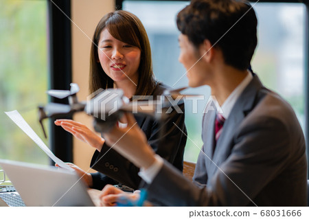 Drone business suit office two men and women frontal in-flight business talk greeting aerial view am bright Drone business suit office two men and women frontal in-flight business talk greeting aerial view am bright 68031666