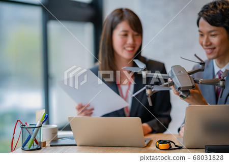 Drone business suit office two men and women frontal in-flight business talk greeting aerial view am bright 68031828