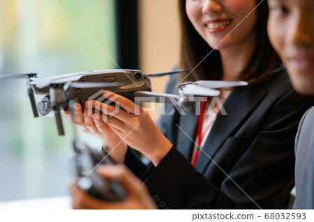 Drone business suit office two men and women business talk aerial view am bright windowside window city center operation 68032593