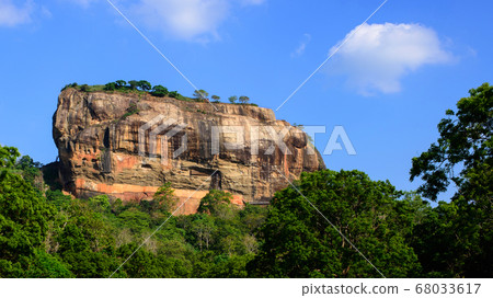 Huge Sigiriya rock towering in the sky 68033617