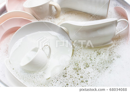 Washing dishes, Close up of utensils soaking Washing dishes, Close up of utensils soaking 68034088