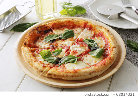 Pizza Margherita on a white table Pizza Margherita on a white table 68034321
