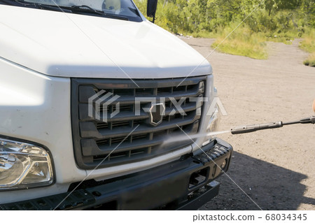 washing the truck with a high-pressure wash 68034345