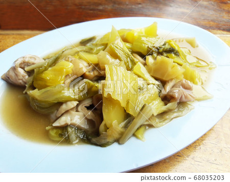 Stir fried pork filling, with pickled lettuce and oyster sauce in white plate Stir fried pork filling, with pickled lettuce and oyster sauce in white plate 68035203