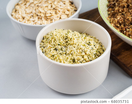 Shelled hemp seeds superfood in white bowl Shelled hemp seeds superfood in white bowl 68035731