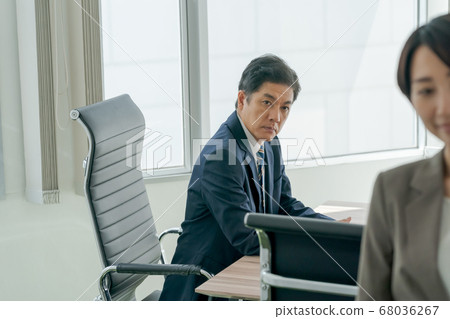 Boss staring at a woman Boss staring at a woman 68036267