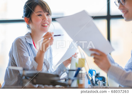 Drone business casual office two male and female business talk aerial view aerial view window hand control hobby flight 68037263