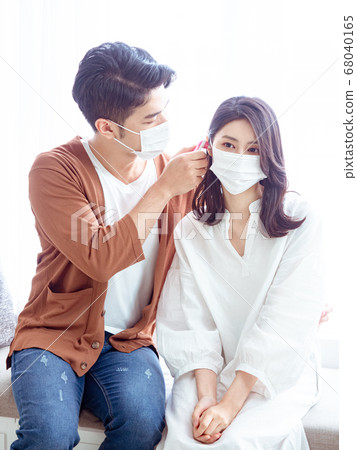Young asian couple wearing surgical mask and using 68040165