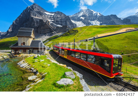 Cogwheel tourist train coming down from the mountain, Jungfraujoch, Switzerland Cogwheel tourist train coming down from the mountain, Jungfraujoch, Switzerland 68042437