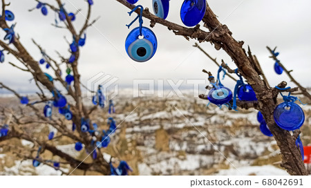 Blue Evil eye charms hang on the tree in Cappadocia, Turkey 68042691